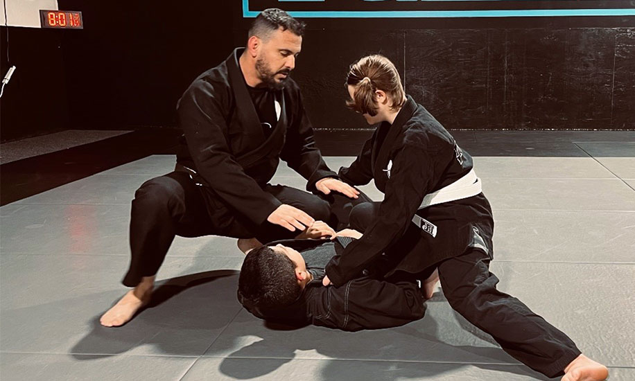 Jiu-Jitsu-Lab-2 Professor teaching two teens Jiu Jitsu